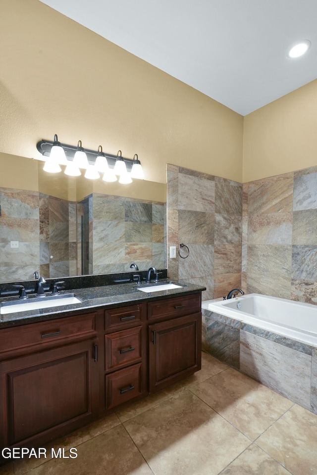 full bath featuring double vanity, tile walls, a sink, and a bath