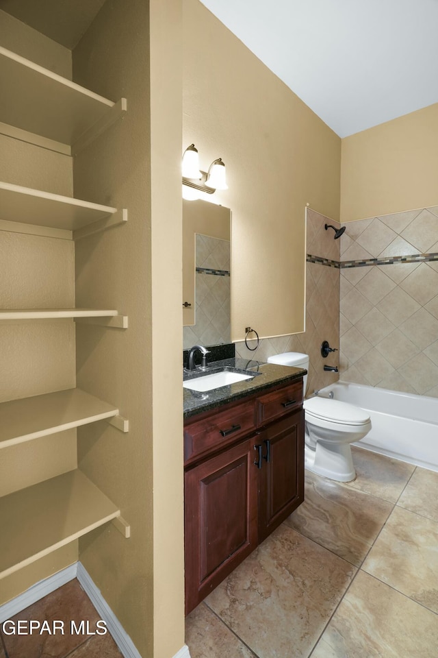 full bath with toilet, tile patterned floors, bathing tub / shower combination, and vanity