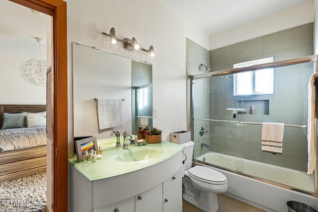 full bathroom with bath / shower combo with glass door, vanity, and toilet