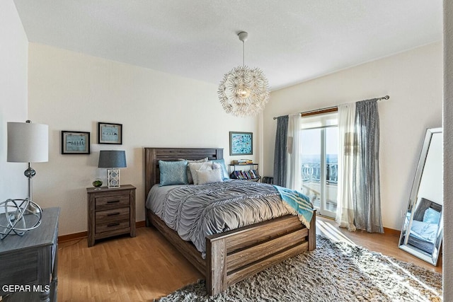 bedroom featuring light wood-type flooring and access to exterior