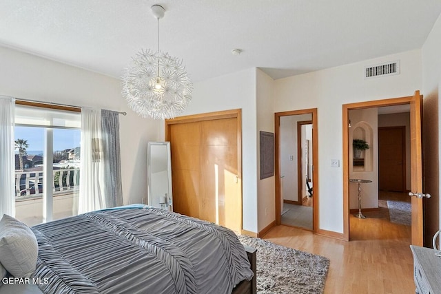 bedroom with light hardwood / wood-style floors and a closet