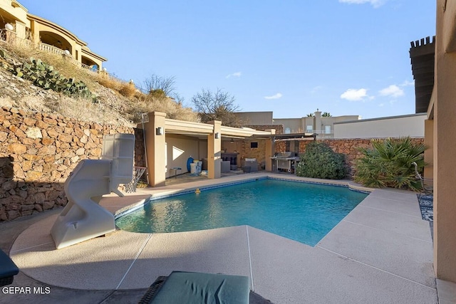 view of swimming pool with a patio area