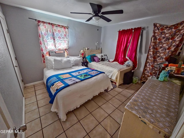 bedroom with light tile patterned floors, a ceiling fan, and baseboards