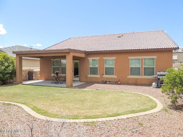 7876 Enchanted Path Dr, El Paso, TX 79911 - rear view of property featuring stucco siding, a tiled roof, a patio, and a yard
