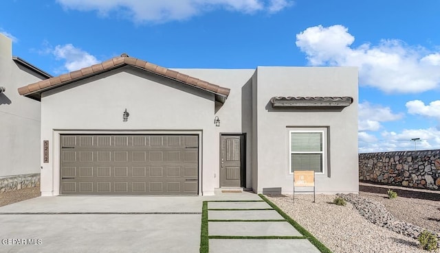 3872 Surmise St, El Paso, TX 79938 - view of front of house featuring an attached garage, concrete driveway, stucco siding, and a tile roof