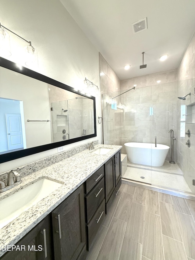 3872 Surmise St, El Paso, TX 79938 - bathroom with a sink, visible vents, a shower stall, and a soaking tub