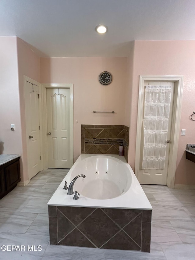 bathroom with tiled bath