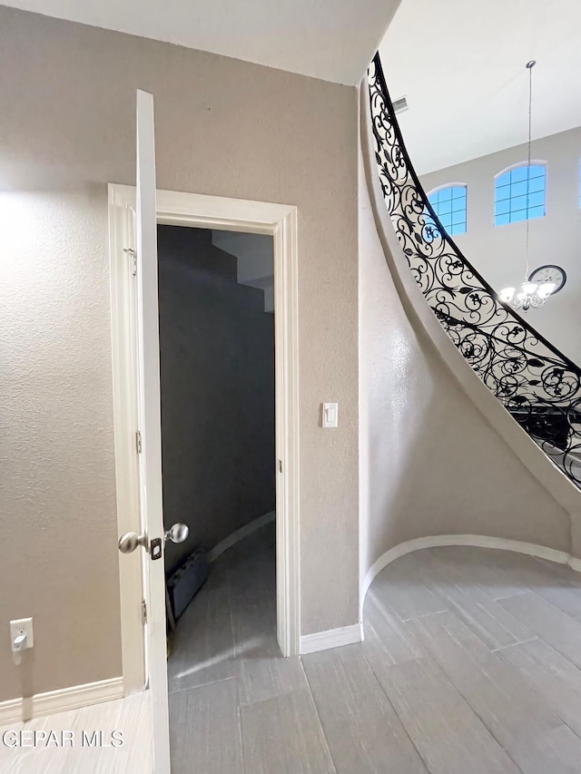 staircase with a chandelier