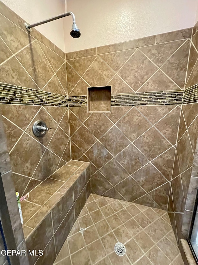 bathroom with a tile shower