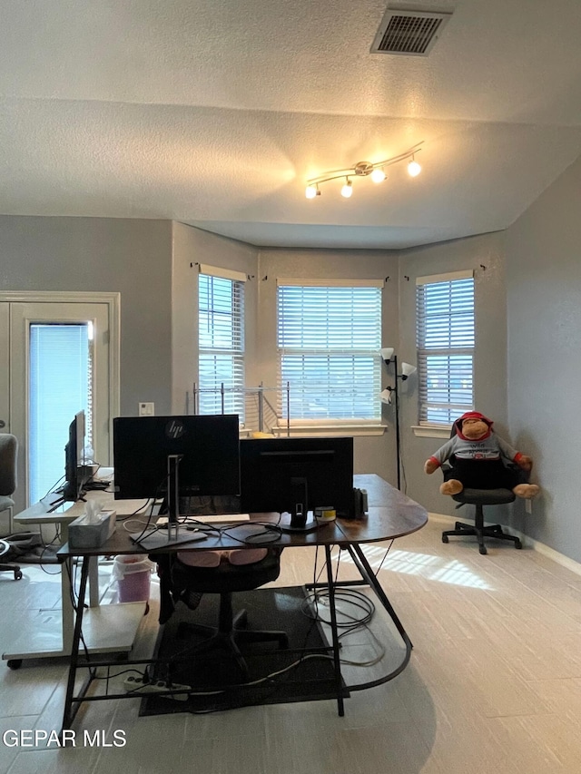 office space with a textured ceiling