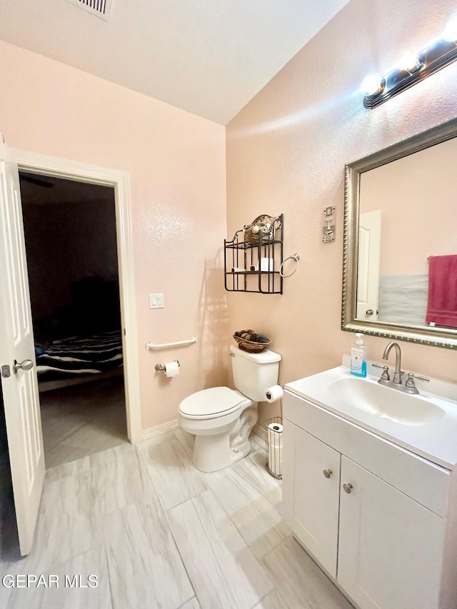 3165 Destiny Point Dr, El Paso, TX 79938 - bathroom with toilet, vanity, baseboards, and lofted ceiling