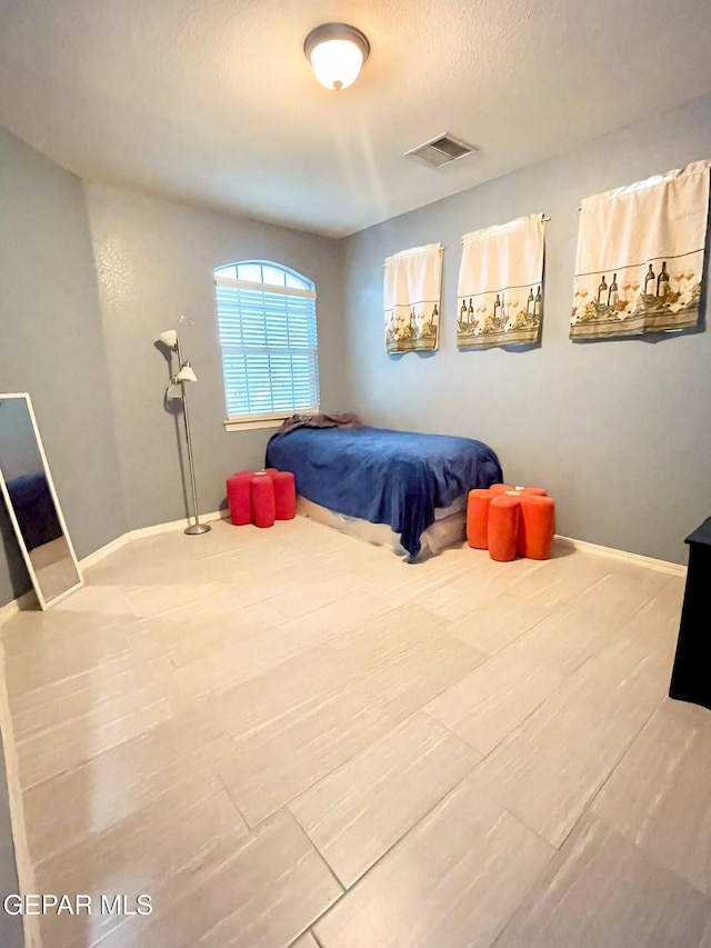 3165 Destiny Point Dr, El Paso, TX 79938 - bedroom with a textured ceiling, wood finished floors, baseboards, and visible vents