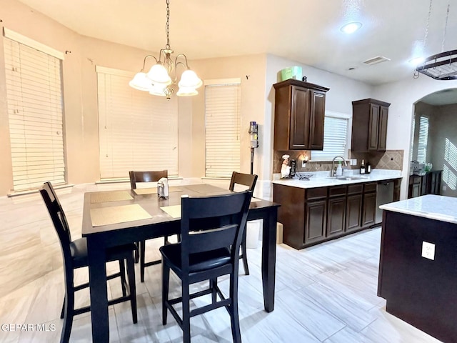 3165 Destiny Point Dr, El Paso, TX 79938 - dining space with arched walkways, visible vents, and an inviting chandelier