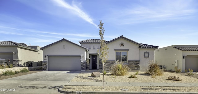 mediterranean / spanish home featuring a garage