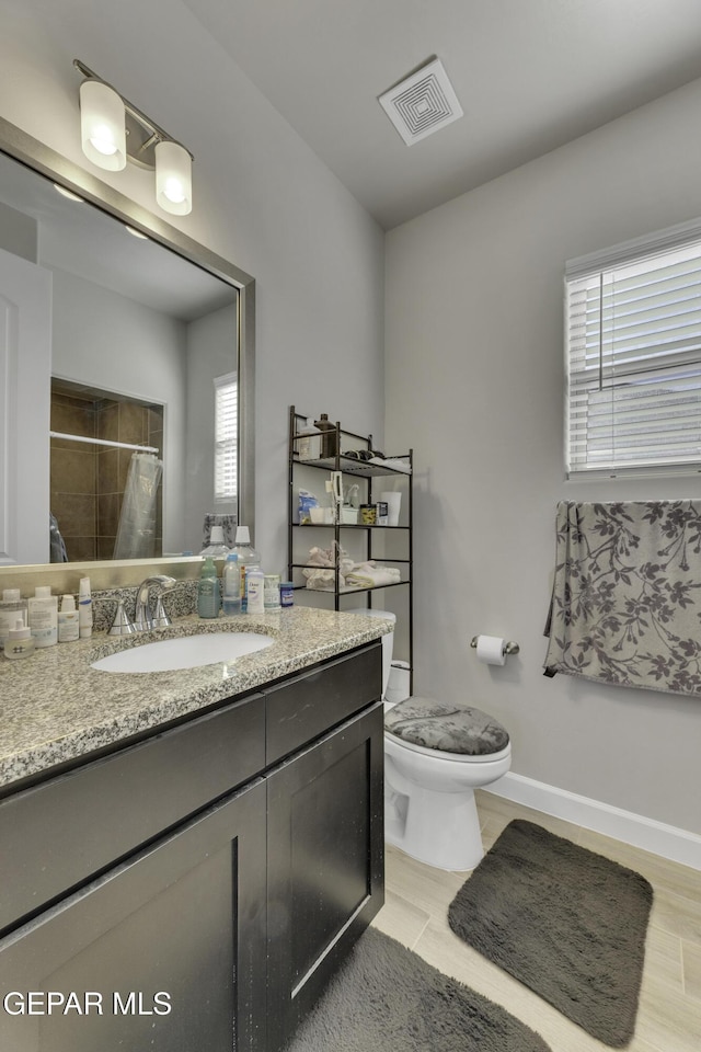 bathroom with vanity, a shower with curtain, and toilet