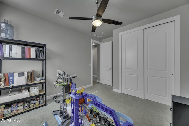 rec room featuring light colored carpet and ceiling fan