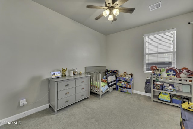 bedroom featuring light colored carpet and ceiling fan