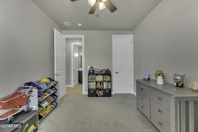 interior space featuring light carpet and ceiling fan