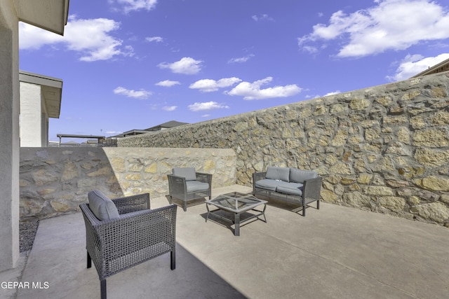 view of patio featuring an outdoor living space with a fire pit