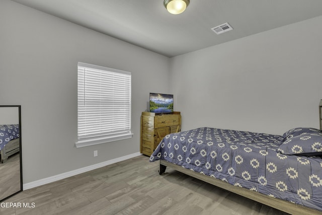 bedroom featuring wood-type flooring