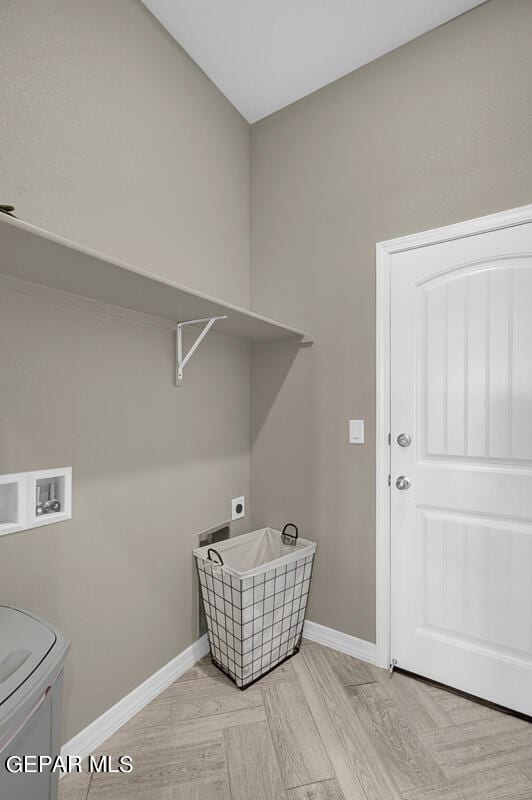 laundry area with washer hookup, light wood-type flooring, and hookup for an electric dryer