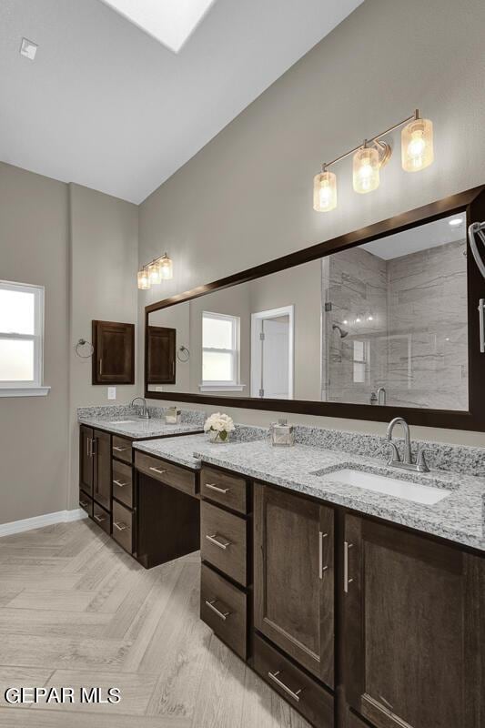 bathroom featuring vanity and a shower with door