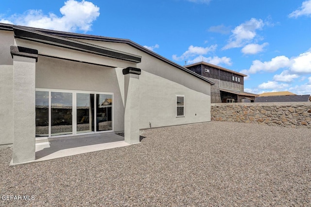 back of property featuring a patio