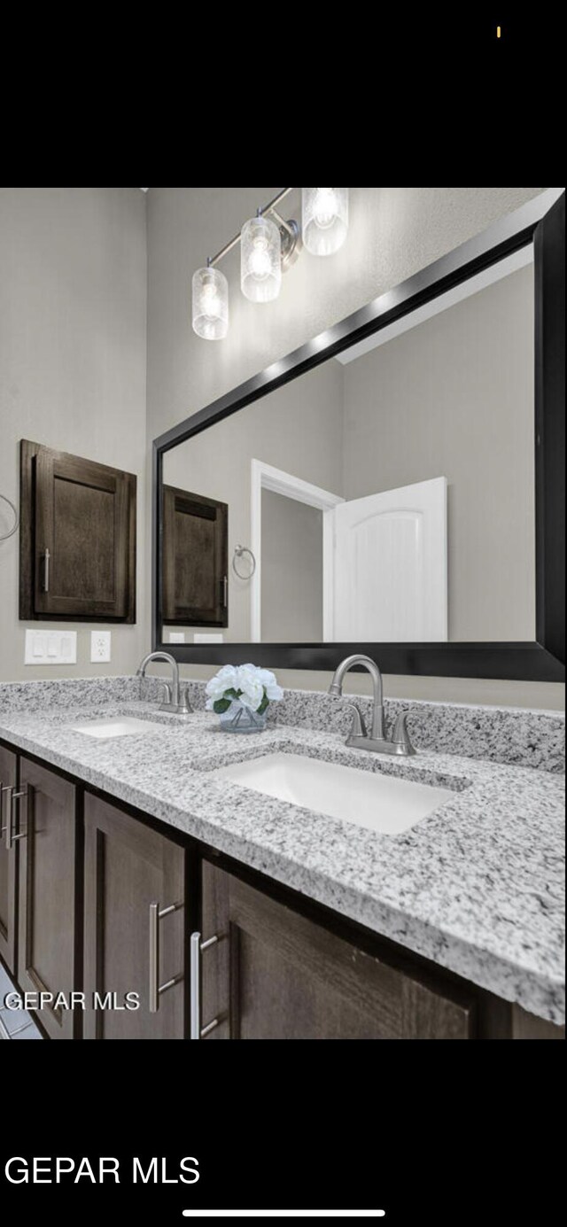 bathroom featuring double vanity and a sink
