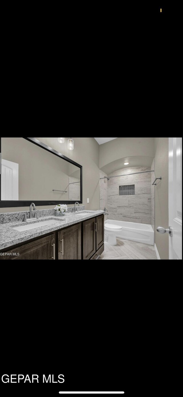 full bath with a sink and double vanity