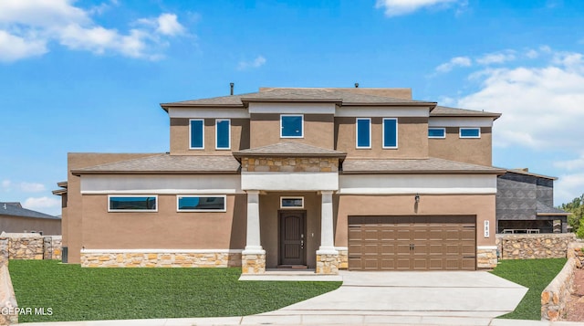 prairie-style house with a garage and a front yard