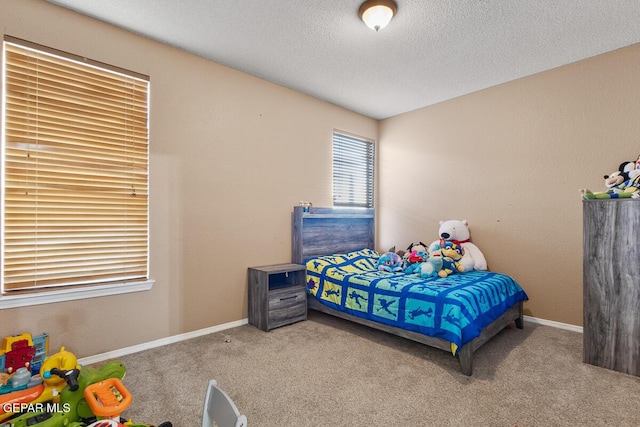 bedroom with light carpet and a textured ceiling