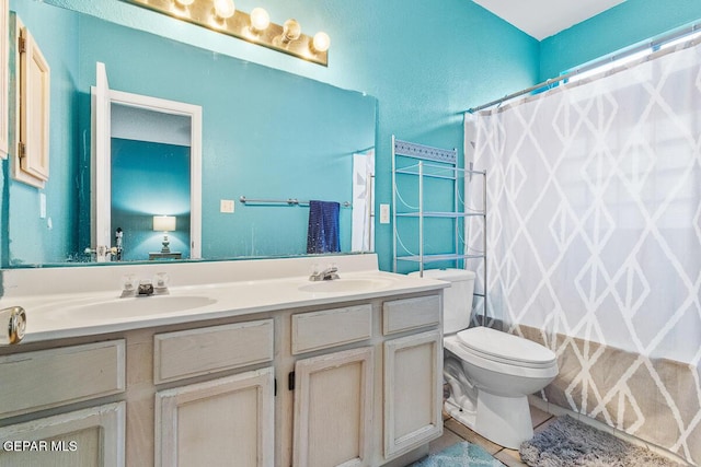 bathroom featuring toilet, vanity, and a shower with curtain