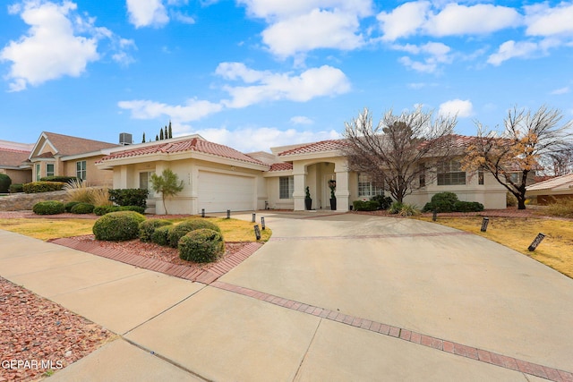 mediterranean / spanish-style home with a garage