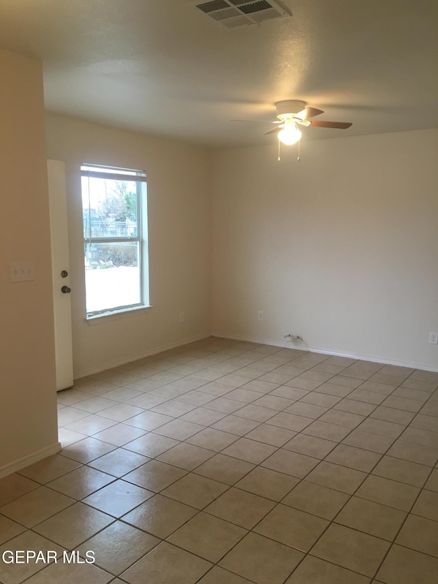 spare room featuring light tile patterned flooring and ceiling fan