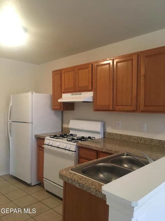 kitchen featuring sink, white appliances, and light tile patterned floors