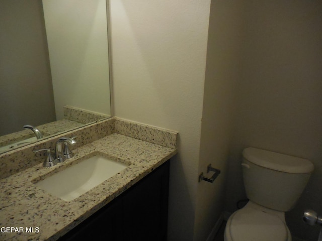 bathroom with toilet and vanity