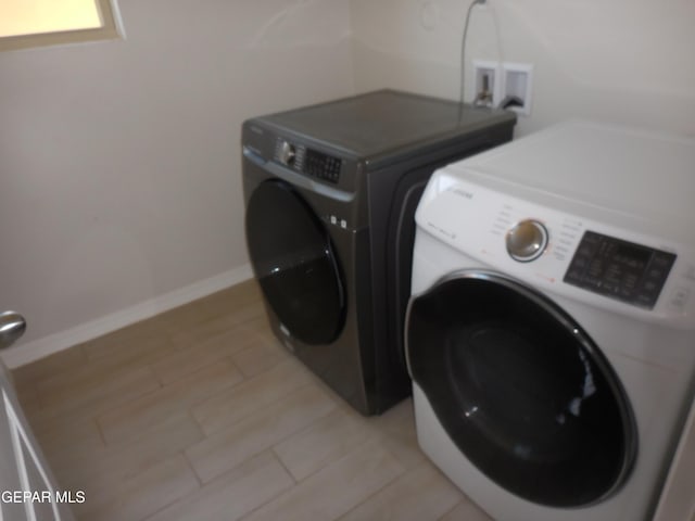 washroom with washing machine and dryer