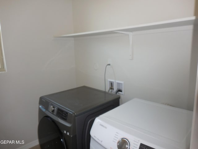 laundry area with washing machine and clothes dryer