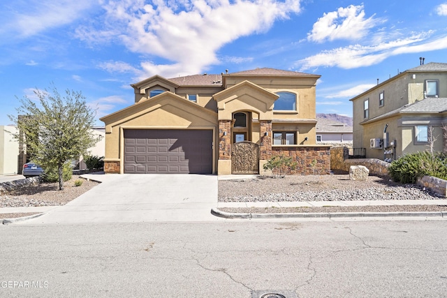 view of front of property featuring driveway, fence, an attached garage, and stucco siding