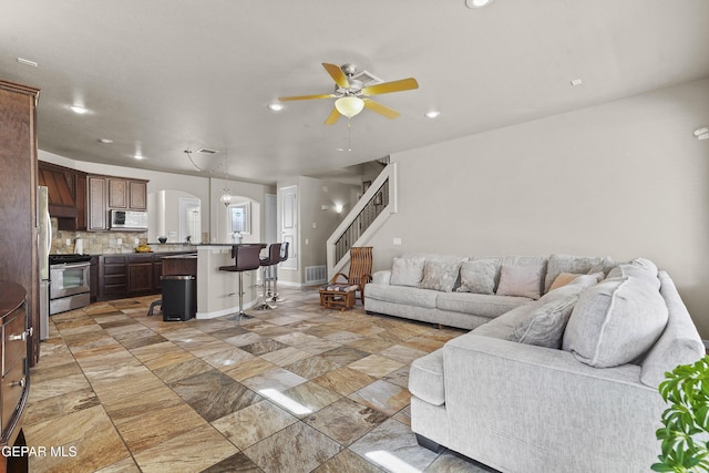 living room with recessed lighting, visible vents, ceiling fan, and stairs