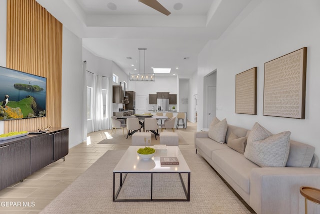 living room with a high ceiling and a tray ceiling