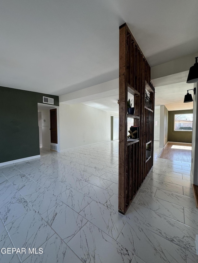 interior space featuring marble finish floor, visible vents, and baseboards