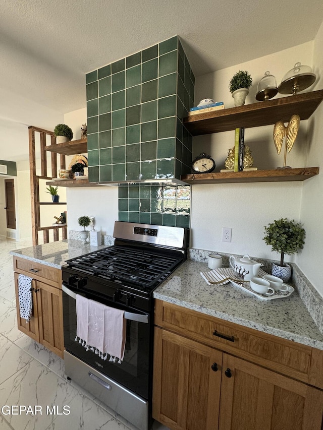 kitchen with light stone counters, gas stove, marble finish floor, and open shelves