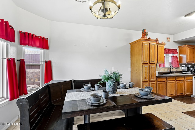 dining space featuring light tile patterned floors and an inviting chandelier