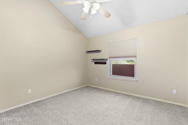 carpeted empty room with vaulted ceiling and ceiling fan