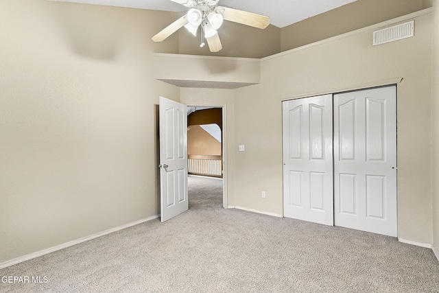 unfurnished bedroom with baseboards, visible vents, a closet, and light colored carpet