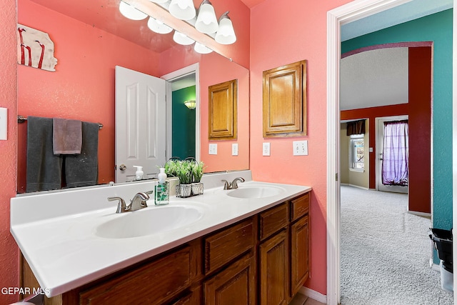 full bath with a sink and double vanity