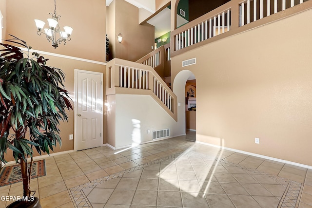 entryway featuring light tile patterned floors, baseboards, and visible vents