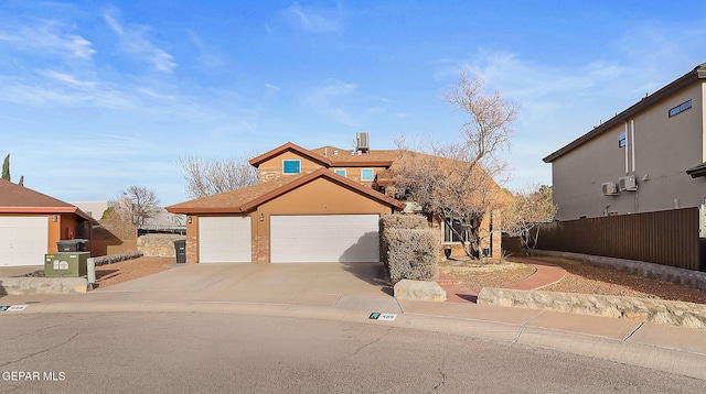 view of front facade with central AC, fence, and concrete driveway