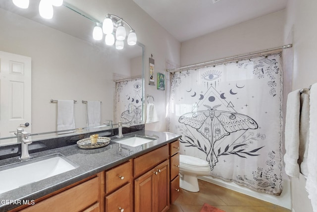 full bathroom featuring double vanity, a sink, toilet, and tile patterned floors